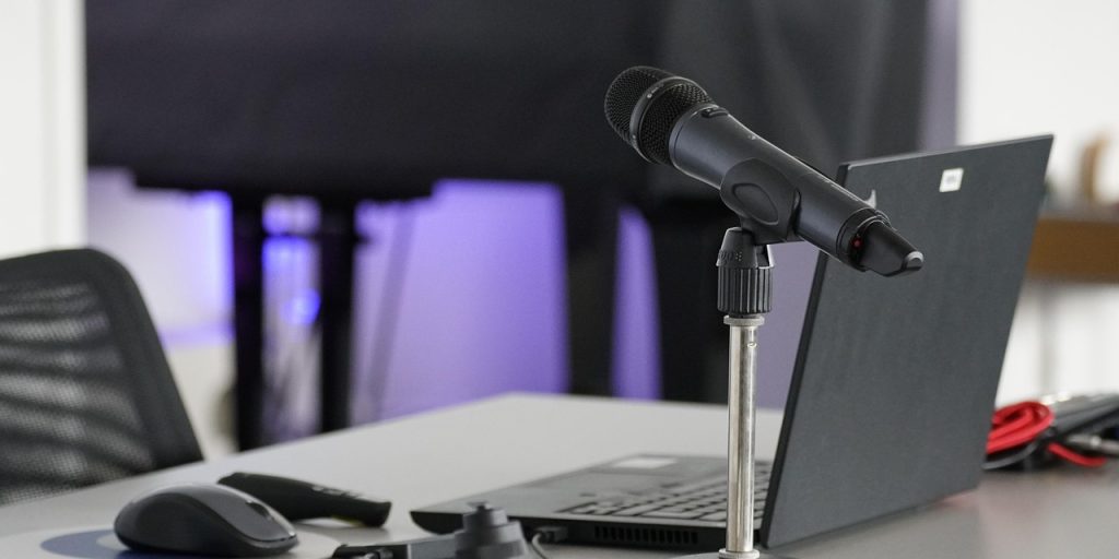 Laptop, conference table, mouse — DC Web Design Agency Focused on Engaging User Experiences
